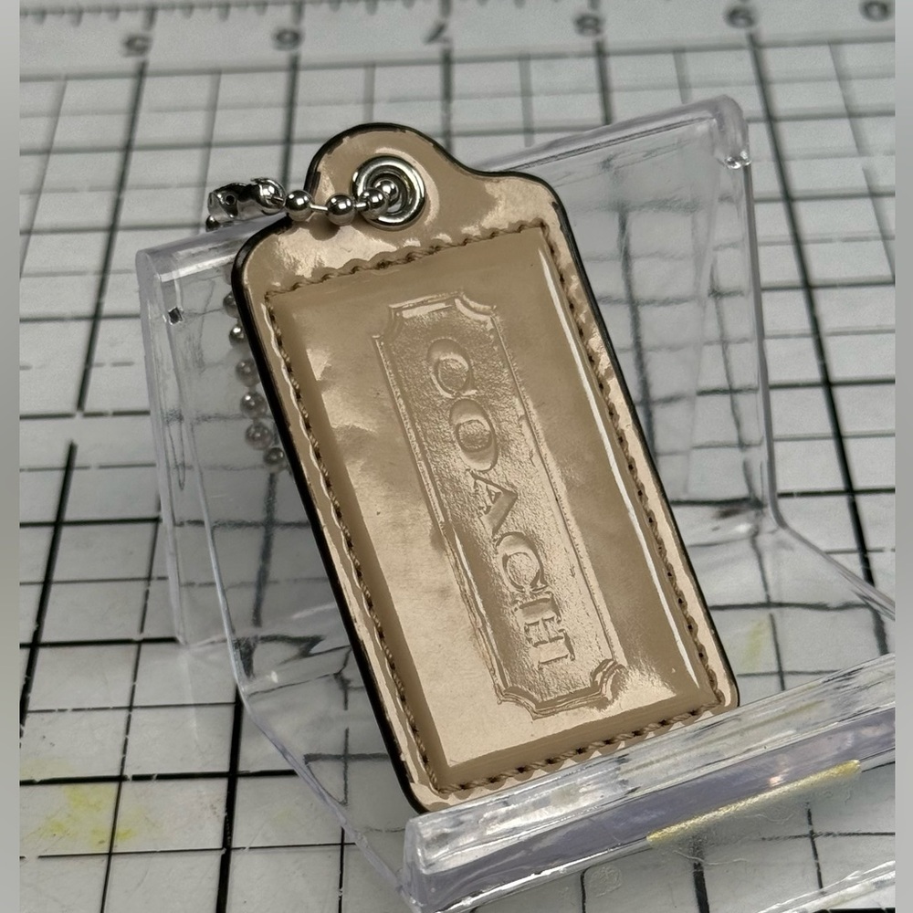 Coach Tan Patent Leather Hang Tag Key Fob medium 3 by 1.5 inches. Brown edge